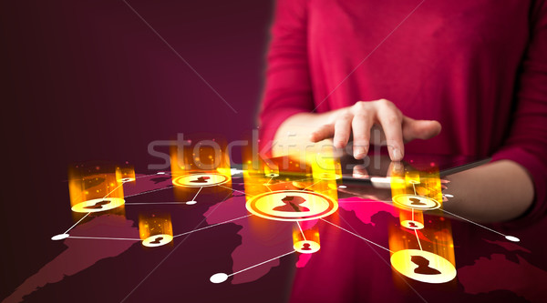 Hand holding tablet device with social network map Stock photo © ra2studio