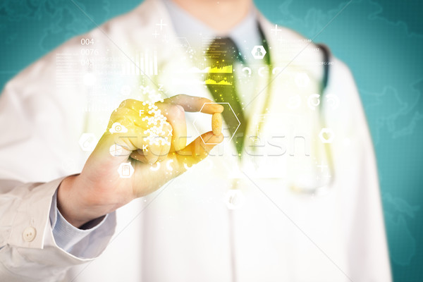 Doctor holding a pill between fingers Stock photo © ra2studio