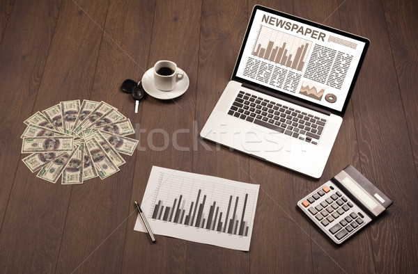 Stock photo: Business laptop with stock market report on wooden desk