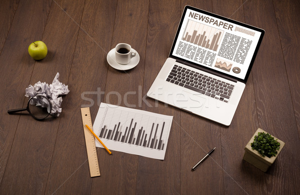 Business laptop with stock market report on wooden desk Stock photo © ra2studio