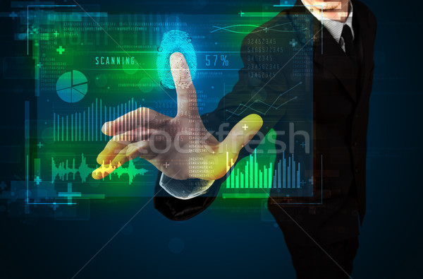Young businessman pressing modern technology panel with finger p Stock photo © ra2studio