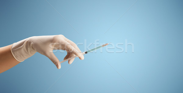 Female doctor holding syringe Stock photo © ra2studio