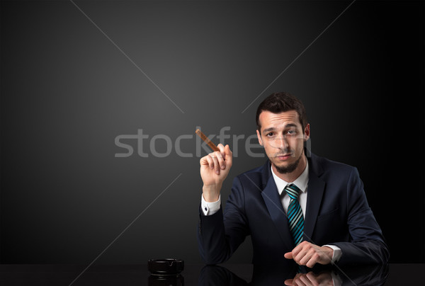 Businessman holding cigarette. Stock photo © ra2studio