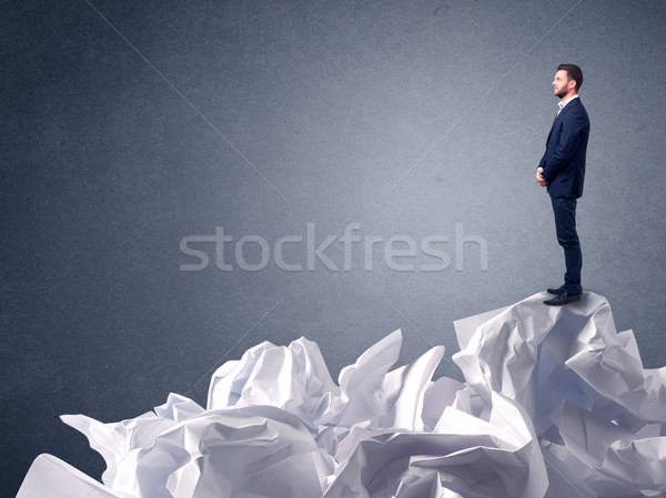 Stock photo: Businessman standing on crumpled paper