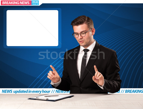Television reporter telling breaking news at his studio desk with copy space  Stock photo © ra2studio