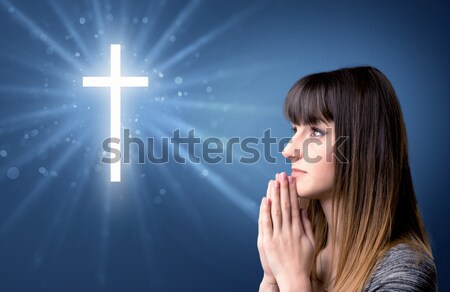 Modląc młoda dziewczyna młoda kobieta niebieski krzyż Zdjęcia stock © ra2studio