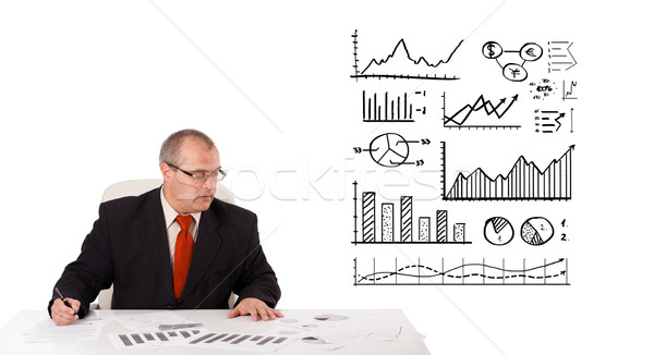 Biznesmen posiedzenia biurko statystyka wykresy odizolowany Zdjęcia stock © ra2studio