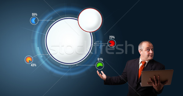 businessman in suit holding a laptop and presenting abstract modern pie chart Stock photo © ra2studio