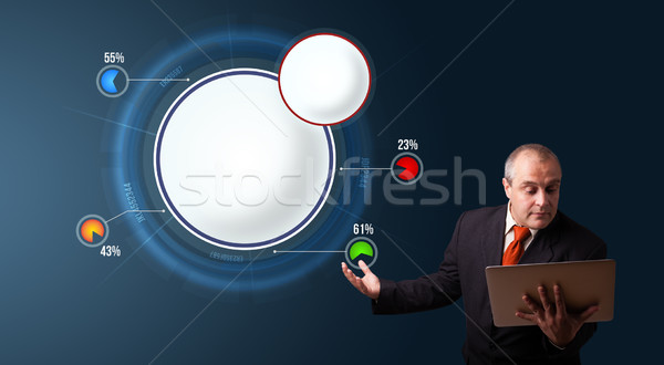 businessman in suit holding a laptop and presenting abstract modern pie chart Stock photo © ra2studio