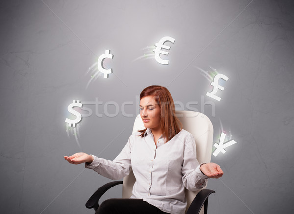 Młodych pani posiedzenia żonglerka waluta ikona Zdjęcia stock © ra2studio