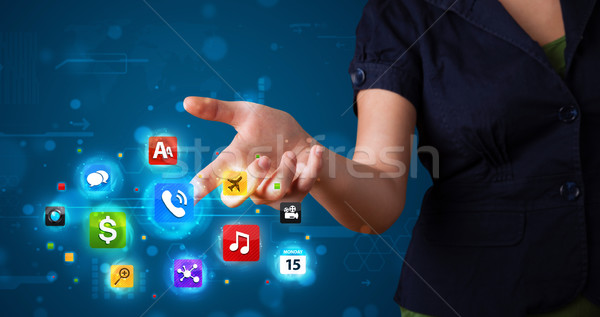 Stock photo: Woman pressing various collection of high tech buttons