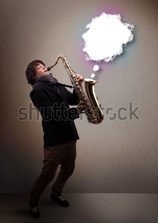 Attractive musician playing on saxophone with colorful abstract  Stock photo © ra2studio