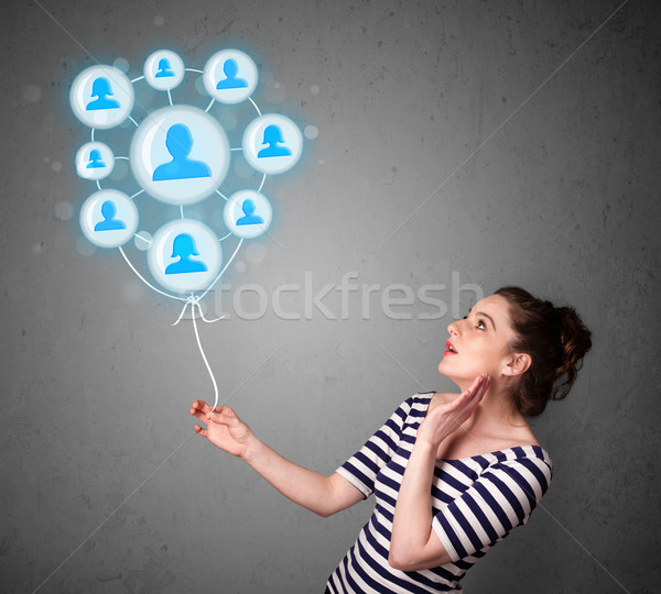 Woman holding social network balloon Stock photo © ra2studio