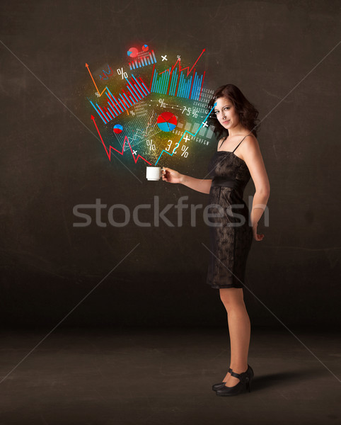 Businesswoman holding a white cup with diagrams and graphs Stock photo © ra2studio