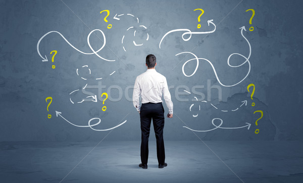 Unsure businessman with question marks Stock photo © ra2studio