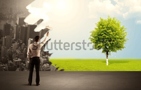 Salesman painting tree instead of city Stock photo © ra2studio