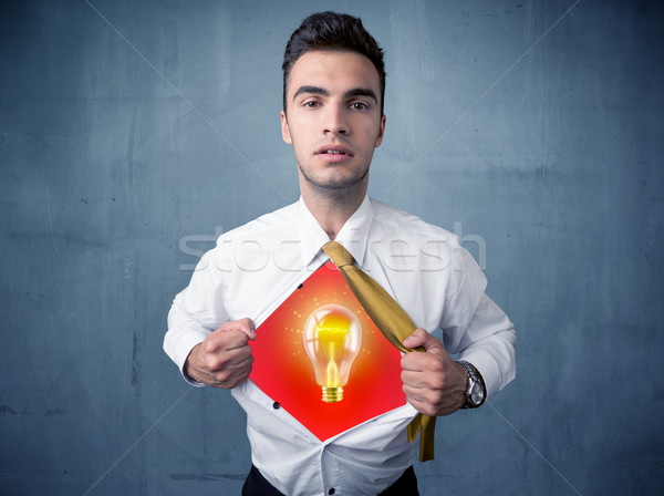 Businessman ripping off shirt and idea light bulb appears  Stock photo © ra2studio