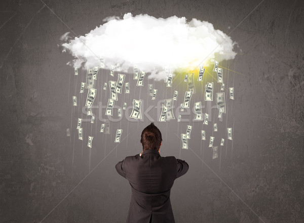 Stock photo: Business man in suit looking at cloud with falling money