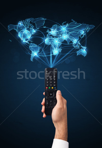 Hand with remote control, social media concept Stock photo © ra2studio