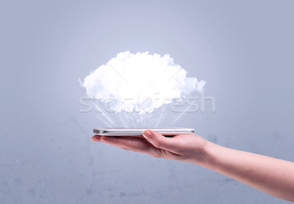 Hand holding phone with empty cloud Stock photo © ra2studio