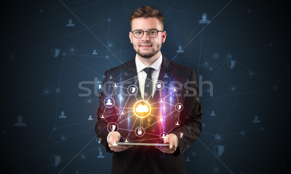 Secured cloud concept with businessman and tablet Stock photo © ra2studio