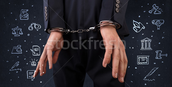 Symbols of courthouse with handcuffed man Stock photo © ra2studio