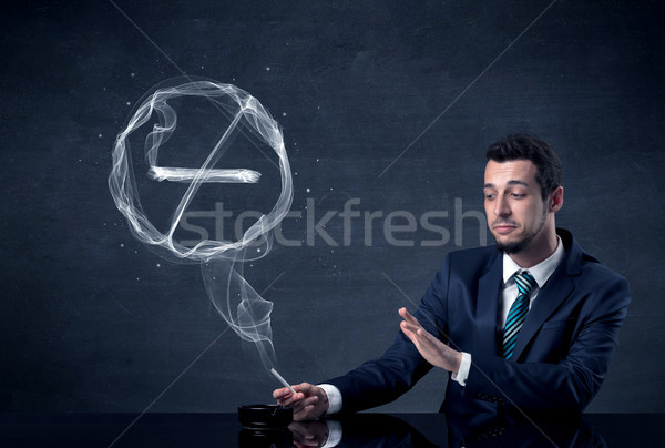 Businessman smoking cigarette. Stock photo © ra2studio