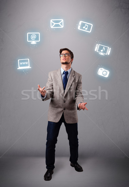 funny boy juggling with electronic devices icons Stock photo © ra2studio