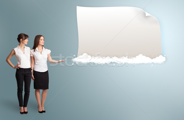 pretty women presenting modern copy space on clouds Stock photo © ra2studio