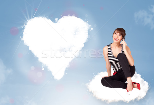Gyönyörű nő ül felhő szív fiatal Stock fotó © ra2studio