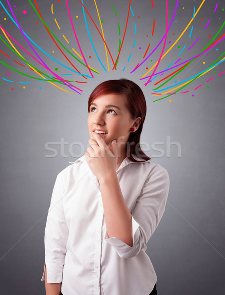 Young girl thinking with colorful abstract lines overhead Stock photo © ra2studio