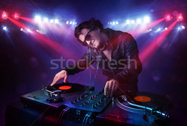 Teenager dj mixing records in front of a crowd on stage Stock photo © ra2studio