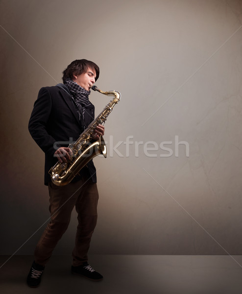 Young musician playing on saxophone Stock photo © ra2studio