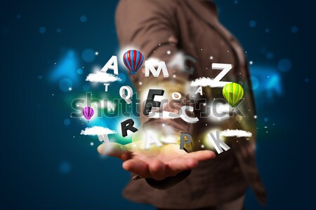 Young businessman presenting magical clouds with letters and bal Stock photo © ra2studio