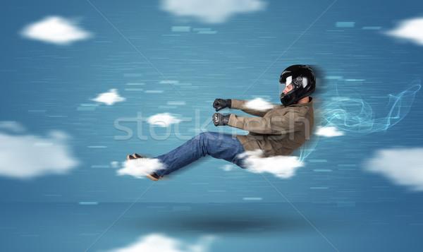 Funny racedriver young man driving between clouds concept Stock photo © ra2studio