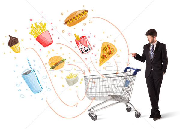 Man with shopping cart with toxic junk food Stock photo © ra2studio