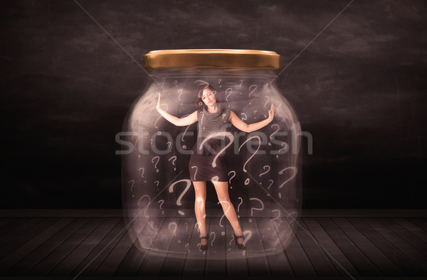 Businesswoman locked into a jar with question marks concept Stock photo © ra2studio