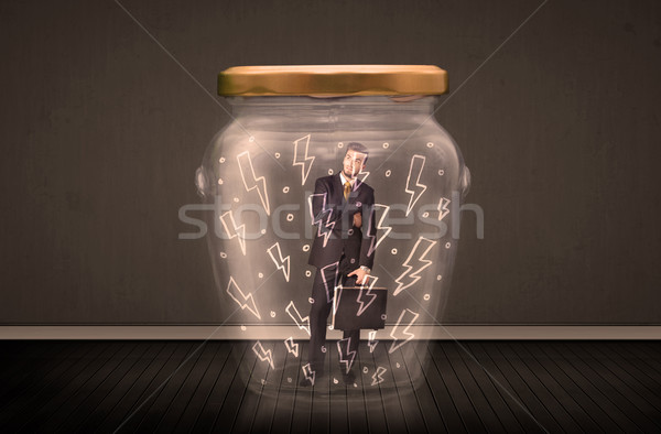 Stock photo: Businessman inside a glass jar with lightning drawings concept