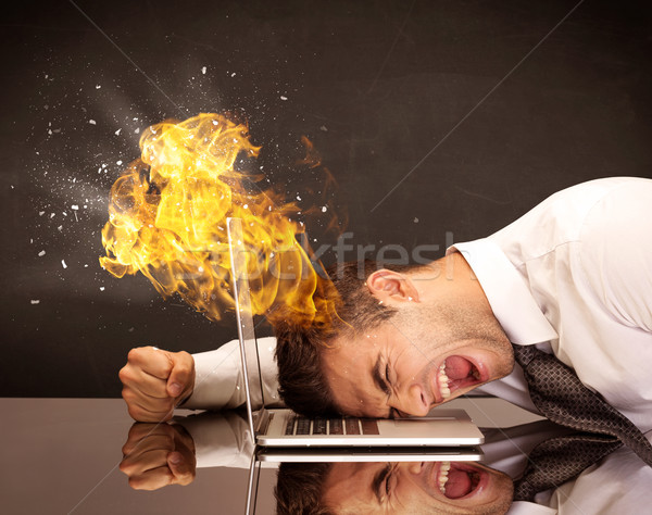 Stressed business man's head is burning Stock photo © ra2studio