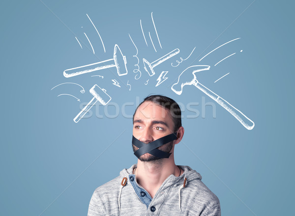 Young man with glued mouth and beating hammer marks Stock photo © ra2studio