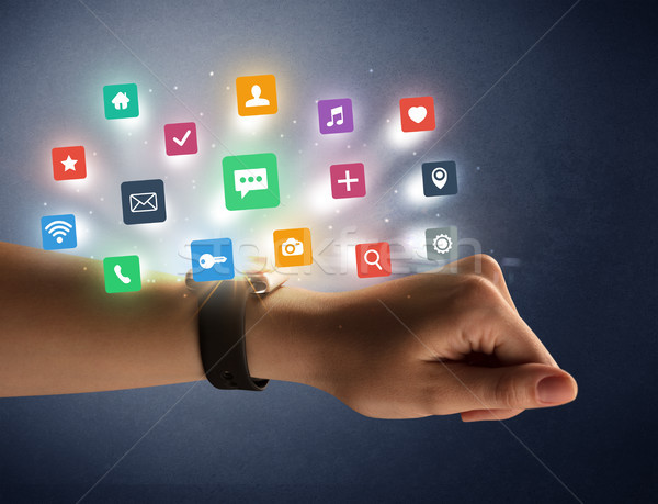 Female hand wearing smartwatch with app icons Stock photo © ra2studio