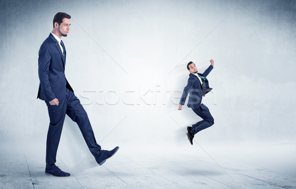 Big businessman kicking small businessman Stock photo © ra2studio