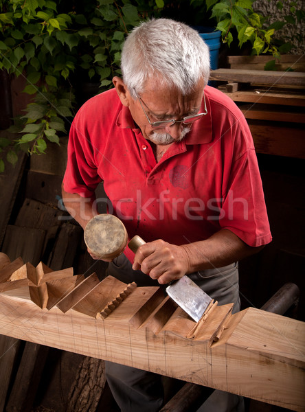 Old woodcarver working with mallet Stock photo © ra2studio