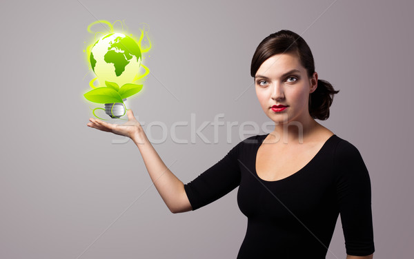 Stock photo: woman holding virtual eco sign