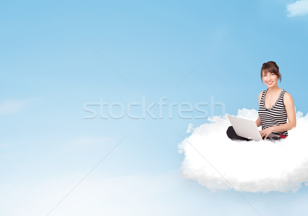 Young woman with laptop sitting on cloud with copy space Stock photo © ra2studio