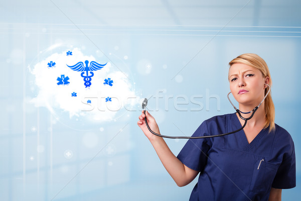 Young doctor with abstract cloud and medical icons Stock photo © ra2studio