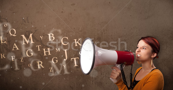 Stock photo: Young girl shouting into megaphone and text come out