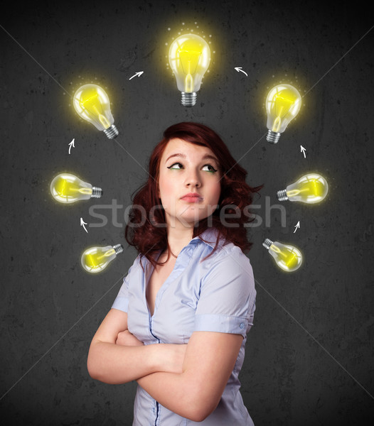 Young woman thinking with lightbulb circulation around her head Stock photo © ra2studio