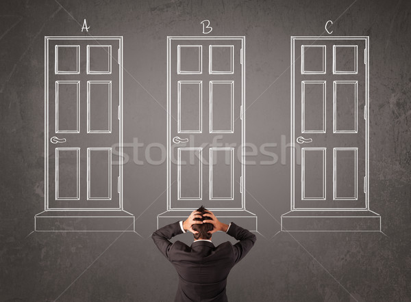 Businessman choosing the right door Stock photo © ra2studio