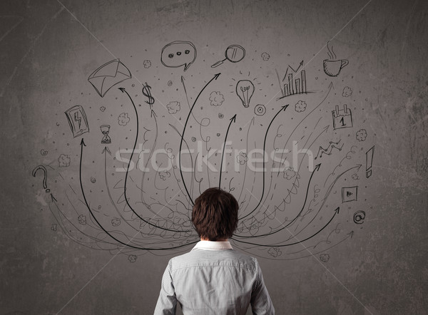 Businessman in front of a chalkboard deciding with arrows and si Stock photo © ra2studio